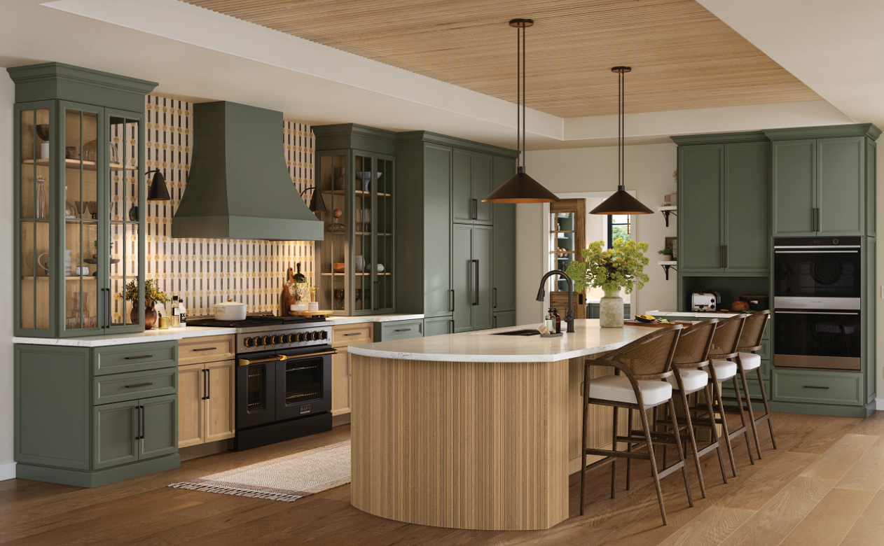kitchen with green cabinetry and rounded kitchen island with reeded wood