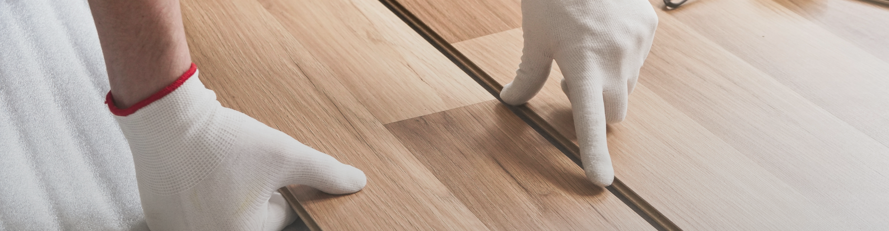 Hardwood planks closeup with hands. 