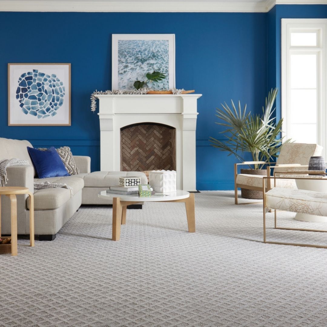 gray patterned carpet in living room with blue walls and decor.